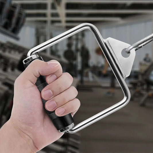 Hand holding a metal pull-up bar with a blurred gym background